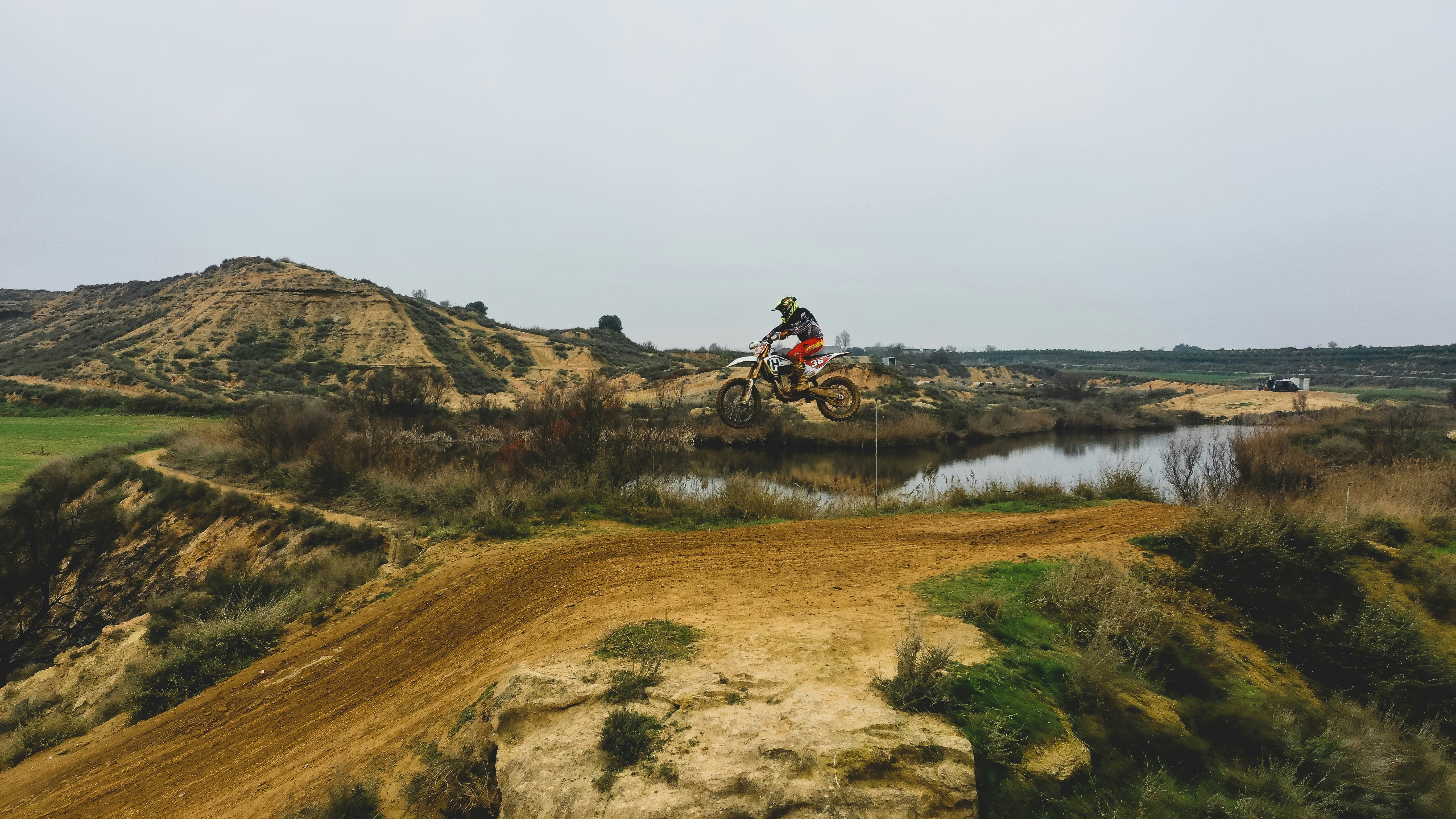 man riding on motorcycle on brown grass field during daytime